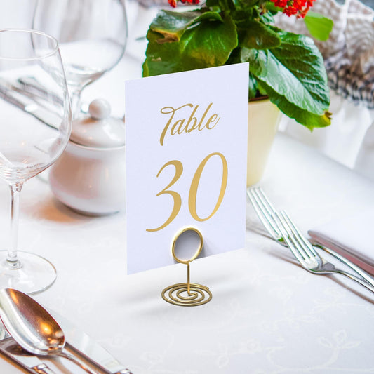 Gold foil table number card “Table 30” on a small stand