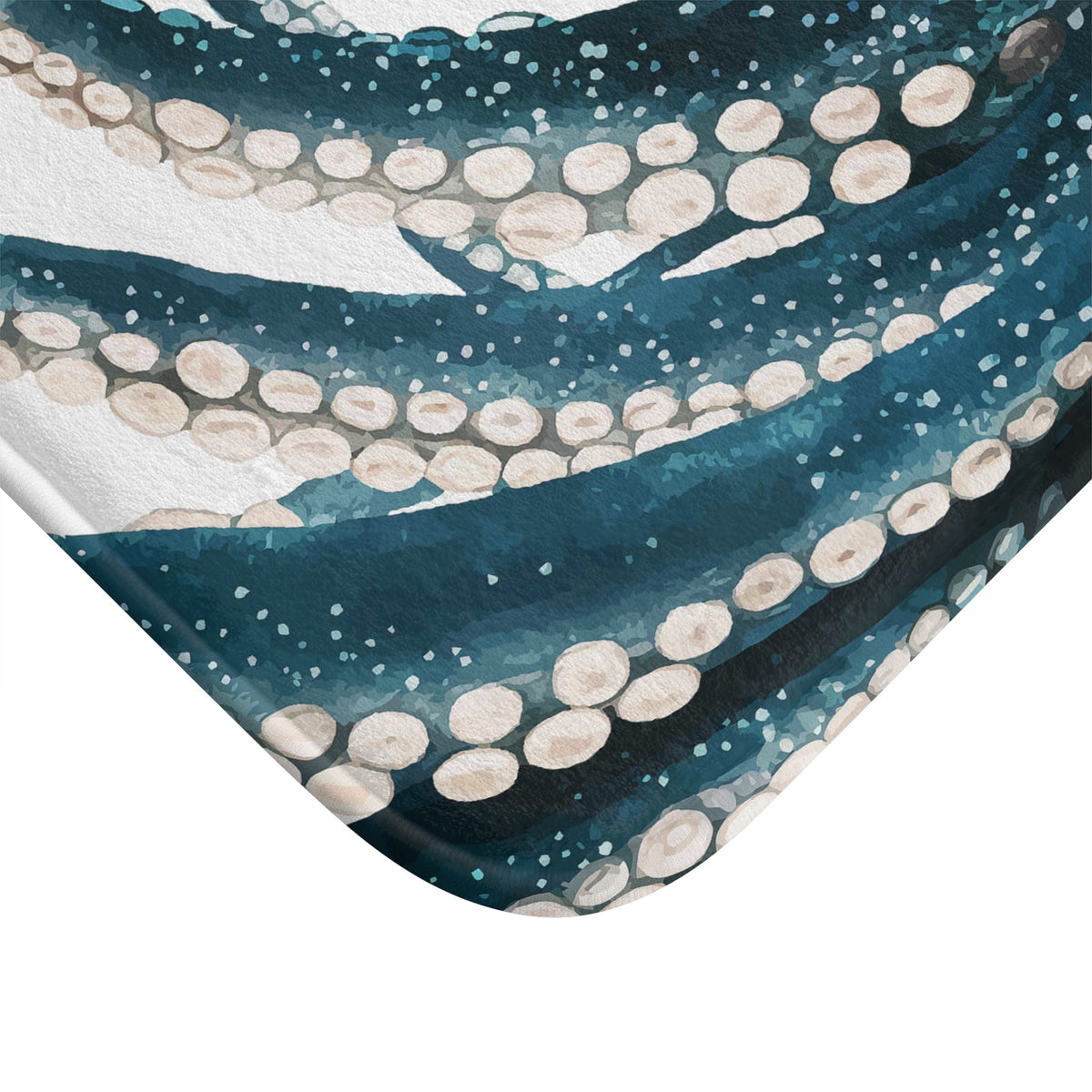 Teal octopus bath mat corner detail with white bubbles and dotted edging, soft foam