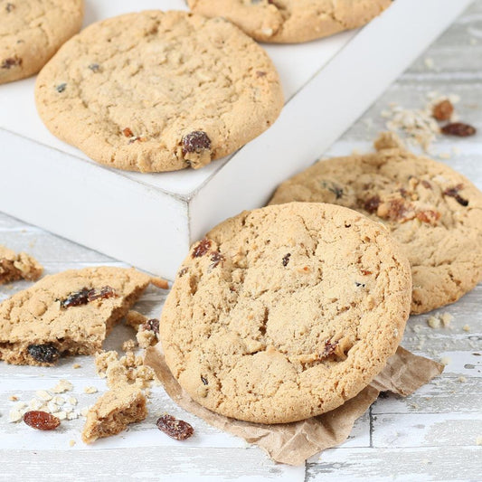 Assorted cookies on white box: chocolate chip, oatmeal raisin, and cookie pieces