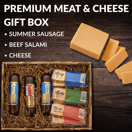 Meat and cheese gift box with sliced cheese, crackers, and salami sausages