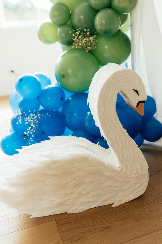 White swan piñata head and beak, wings spread, textured feather details