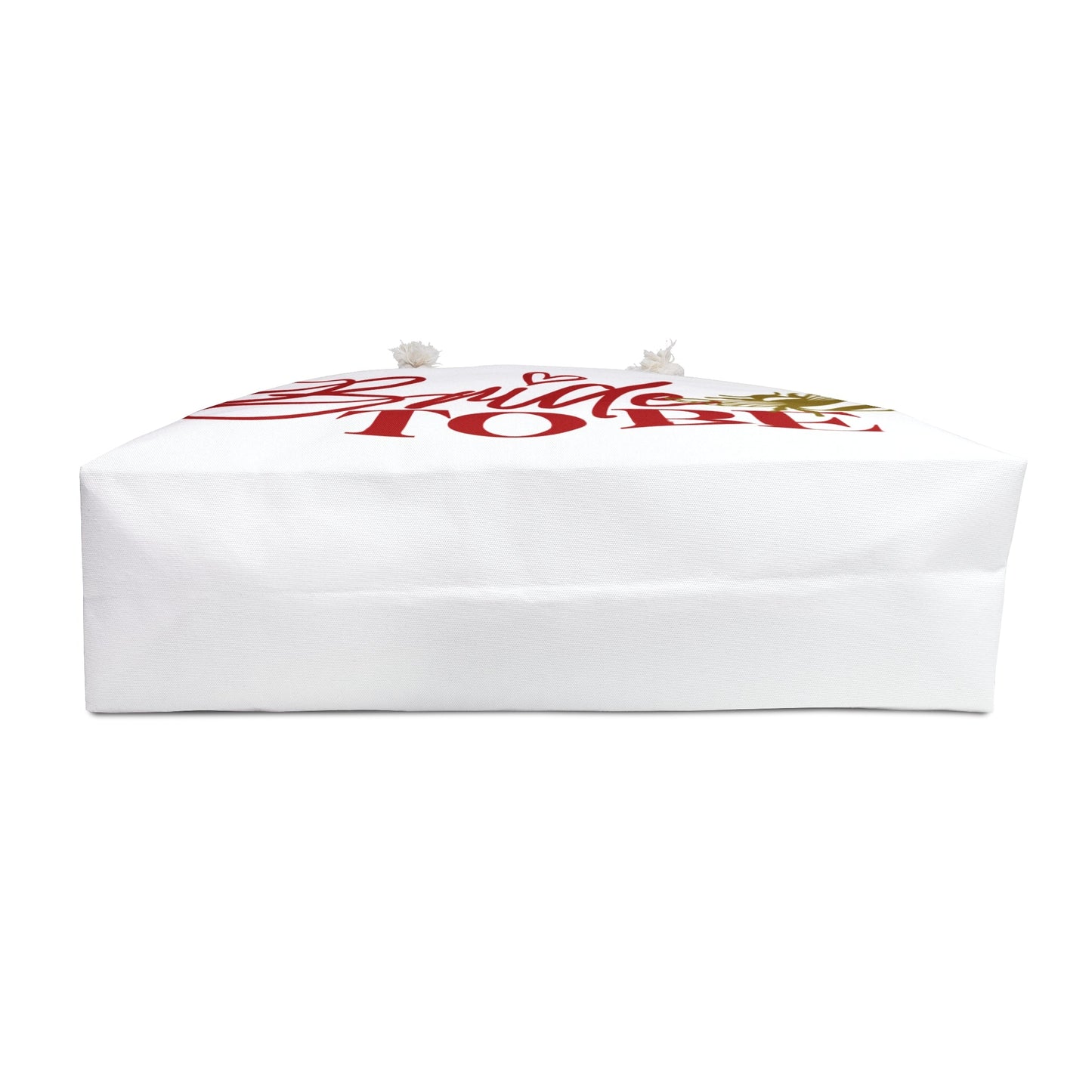 White weekender tote bag folded flat with red 'Bride To Be' lettering on top
