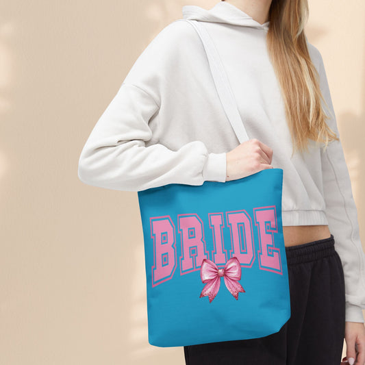 Turquoise tote bag with pink BRIDE print and bow, black shoulder handles