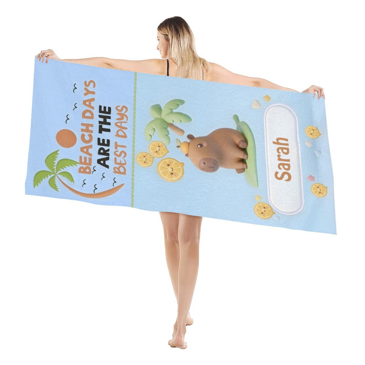 Light blue towel held up, showing bear, palms, lemons, and Saran border patch.