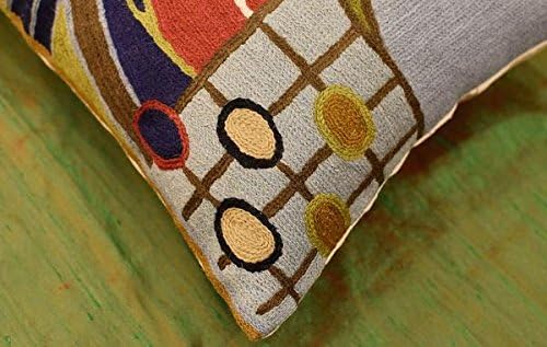Lumbar pillow cover corner with geometric grid, circles, and multicolor stitched yarn