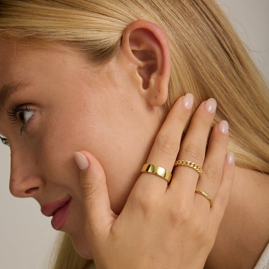 14K gold-filled bold band ring on finger with sunburst engraving, polished yellow gold