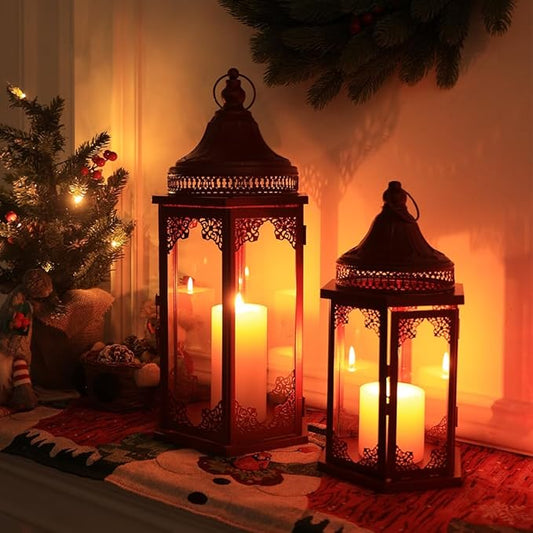 Red metal lantern set with glass panels and visible candle flames