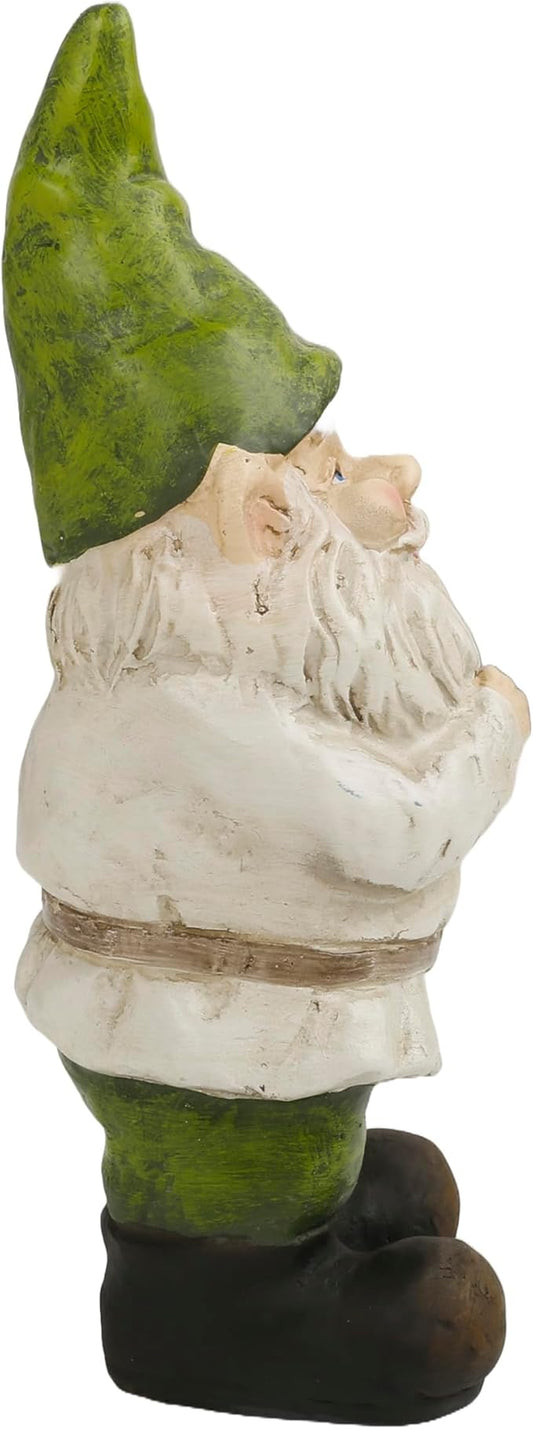 Garden gnome yard statue in profile view with green hat and white beard, standing.
