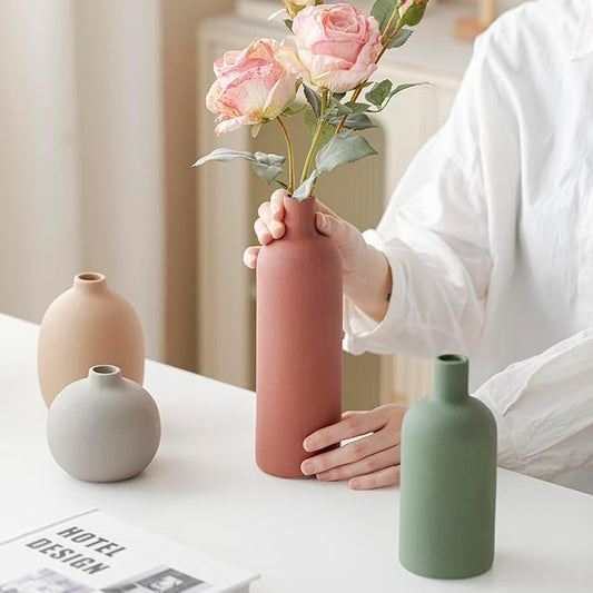 Set of 4 matte ceramic vases: peach, off-white, and green bottles plus pink vase