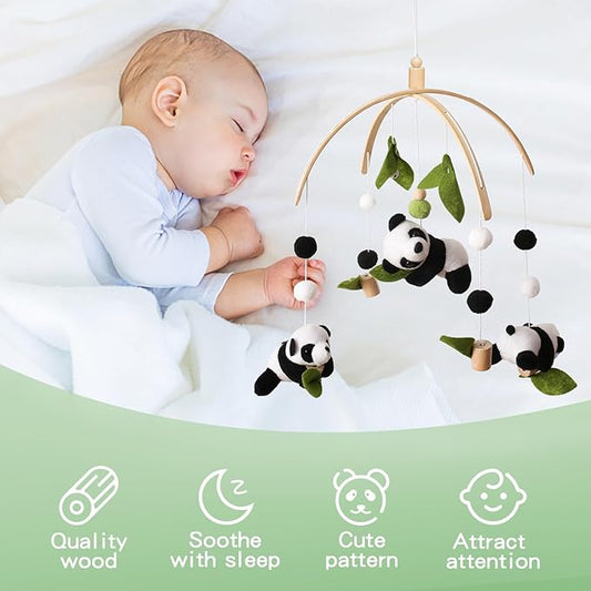 Panda crib mobile above a sleeping baby, wooden arch with panda plush and pom-poms