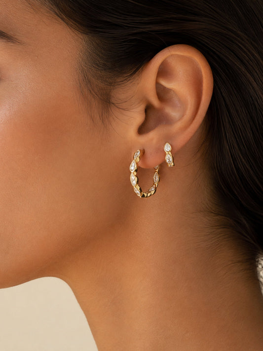 Gold marquise hoop earring with clear stones, shown in profile on ear