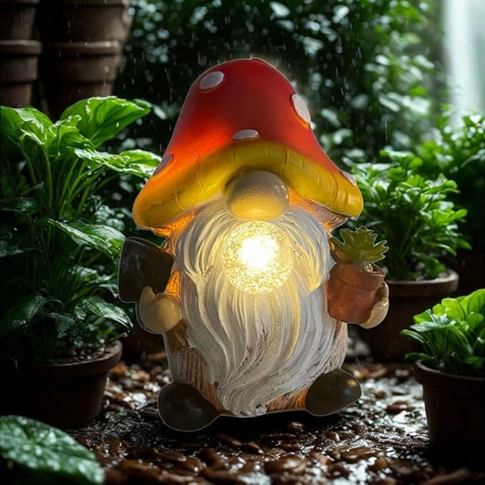 Red solar mushroom gnome statue with glowing orb, holding a small potted plant outdoors