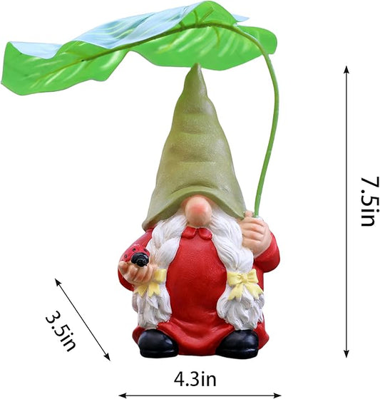 Garden gnome figurine with red outfit and white beard holding green leaf umbrella, front view