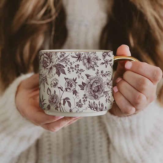 Porcelain mug with purple floral pattern, gold-trimmed handle
