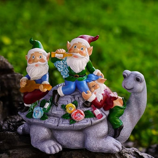 Solar LED garden figurine: three gnomes celebrating on a turtle with a glowing campfire base