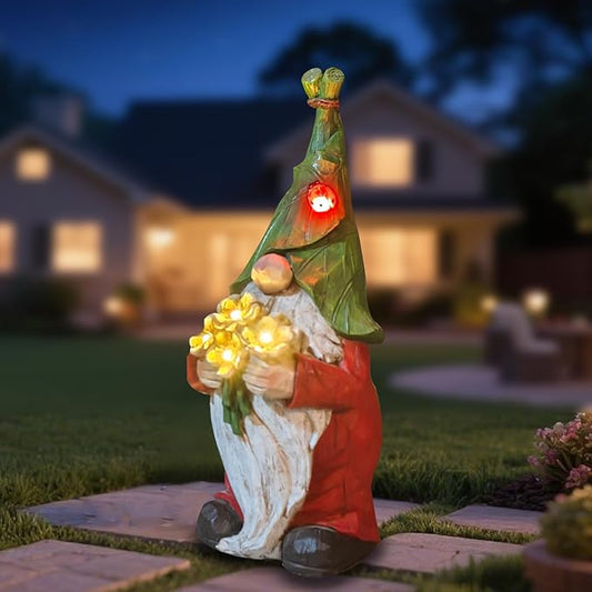 Green and red solar garden gnome figurine holding flower bouquet, lit from chest area