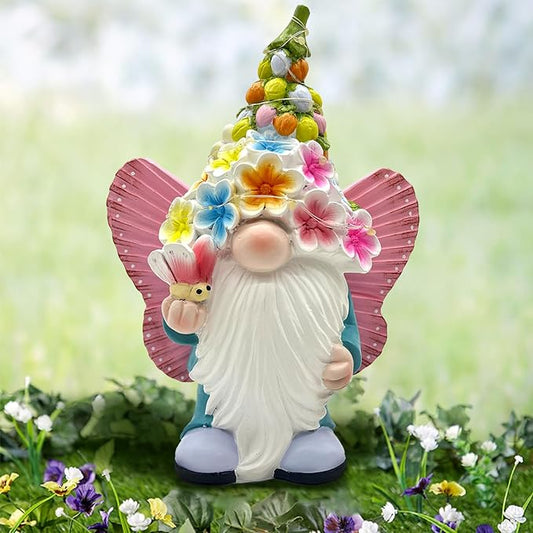 Solar garden gnome statue with pink butterfly wings and glowing warm LEDs, front view