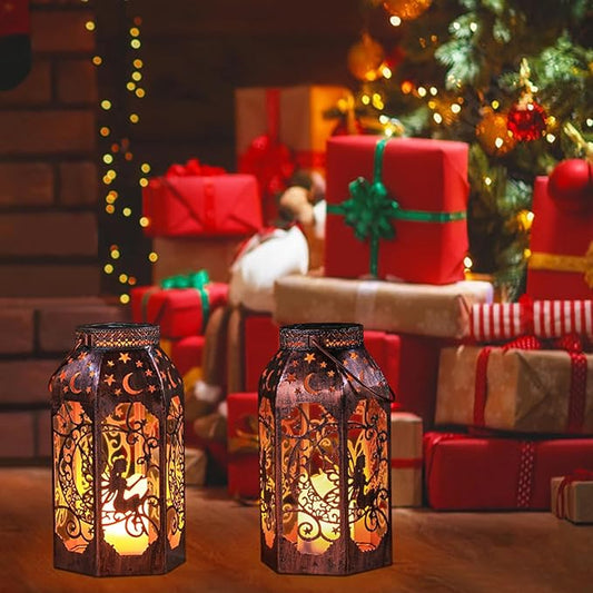 Pair of bronze solar LED lanterns with moon-star cutouts, warm flickering light, outdoor setting