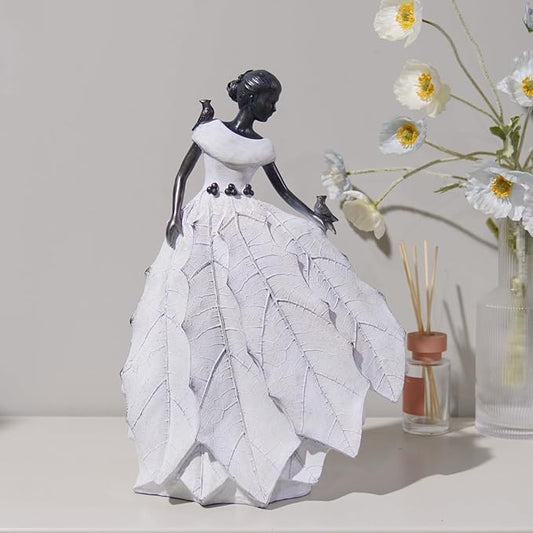 White resin fairy maiden statue standing with layered skirt and raised hand bird figure