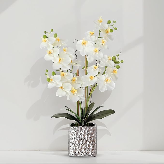 Faux white Phalaenopsis orchids with green buds in a silver textured square vase