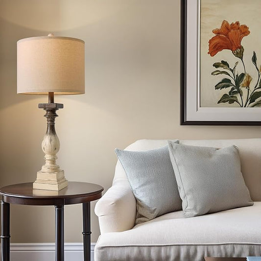Rustic bedside table lamp with beige fabric shade and whitewashed turned base
