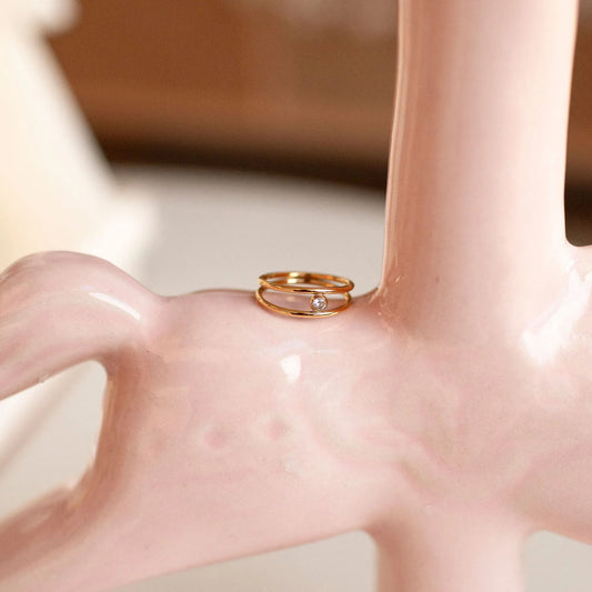 Double-band ring with a round cubic zirconia stone, shown upright