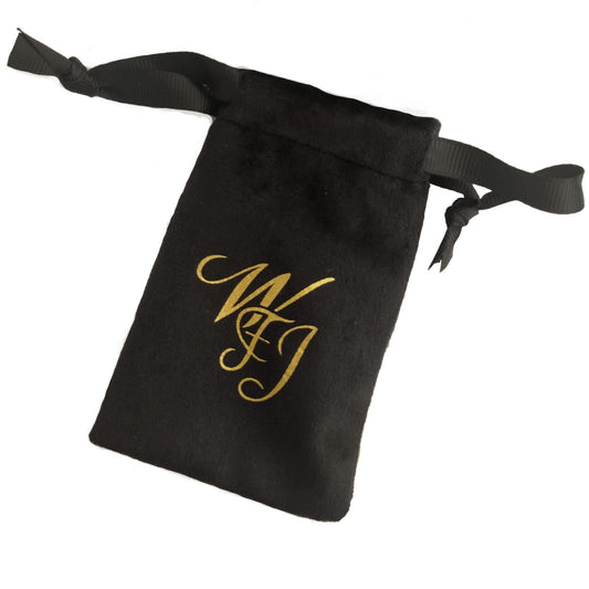 Black drawstring pouch with gold monogram, for carrying the bracelet set