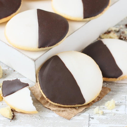 Close-up cookies: white filling with dark chocolate halves and a crumbly cookie base