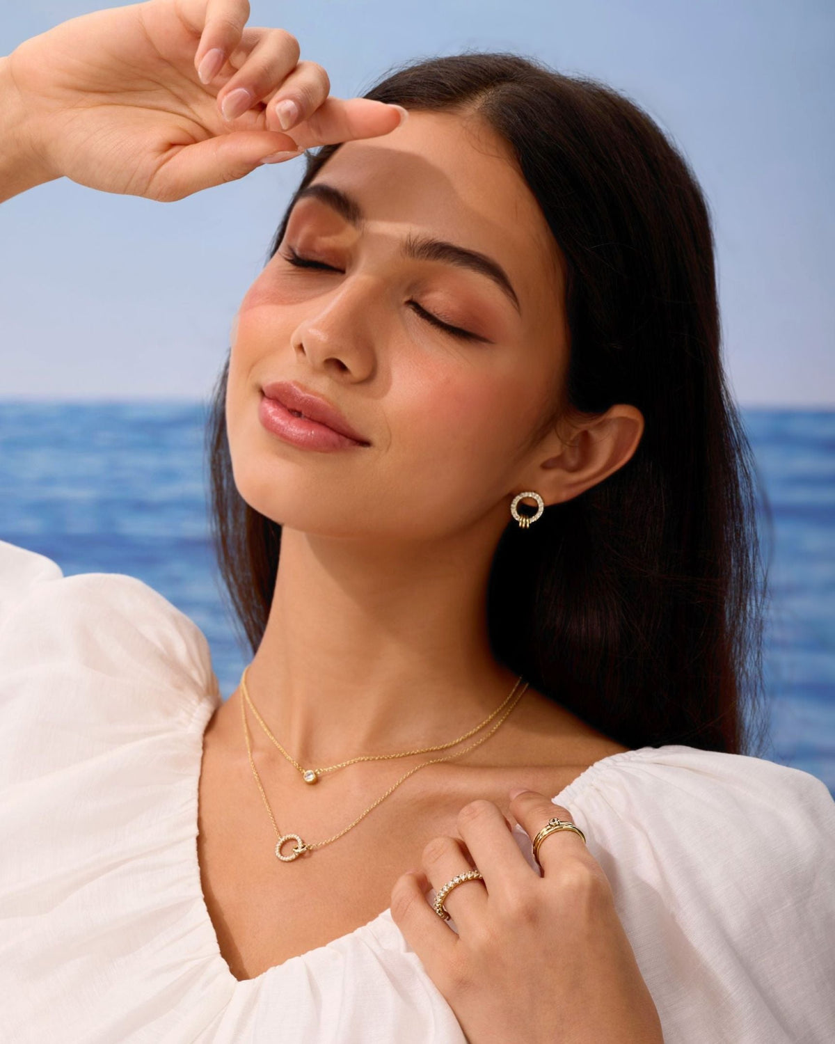 Gold pavé circle stud earrings worn on model