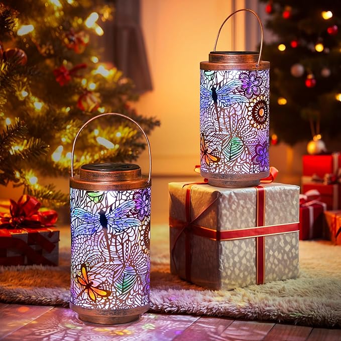 Two solar dragonfly lanterns with multicolor cutout design and copper tops with handles