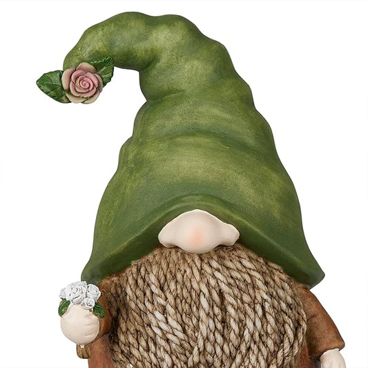 Standing gnome with green hat and woven burlap sack, holding a small pink flower
