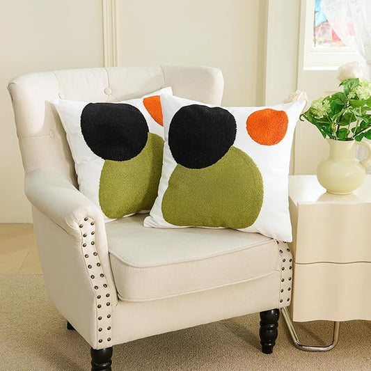 Boho tufted pillow cover set on sofa with black and orange circles and olive-green shapes