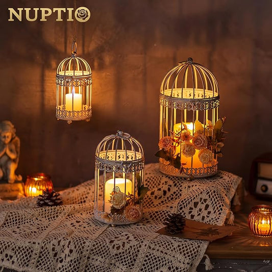 Gold-toned birdcage candle lantern with candle flames inside, ornate dome top