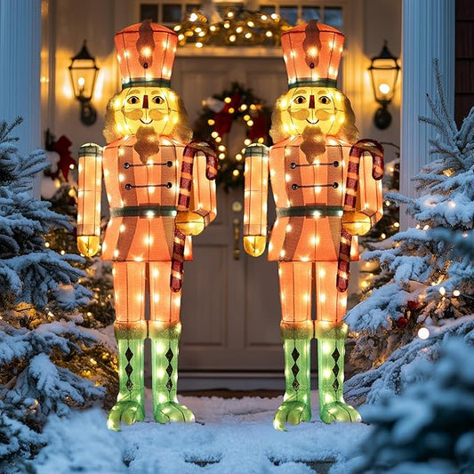 Pair of LED-lit nutcracker yard stakes in red-and-white coats with glowing green boots