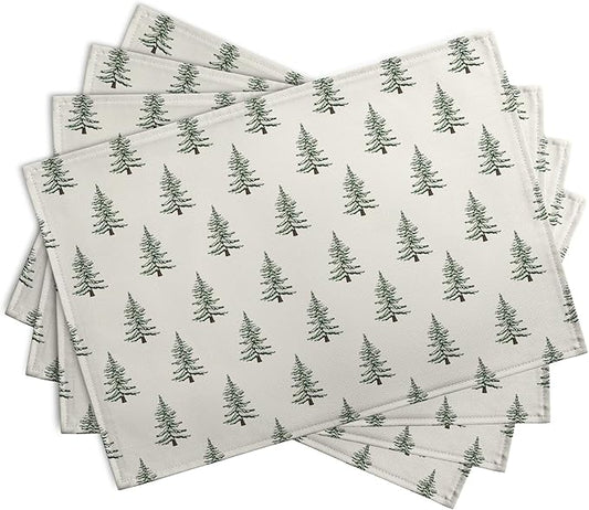Folded set of four Christmas tree placemats, white with green pine tree print, cotton-linen