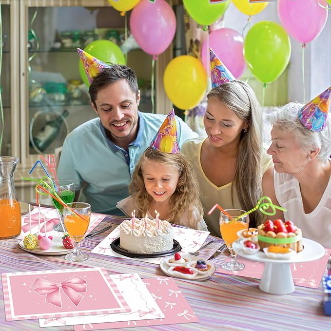 Pink plastic placemat with bow and star pattern on a birthday table