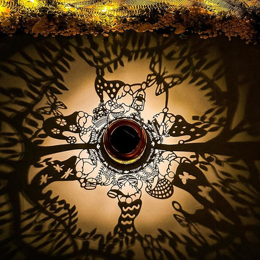 Solar lantern top view with glowing cutout gnome pattern inside metal jar
