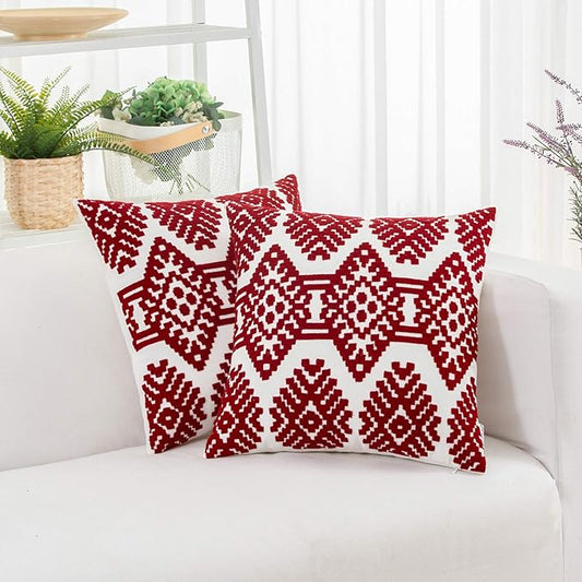 Red throw pillow cover with bold diamond and zigzag embroidery on white fabric
