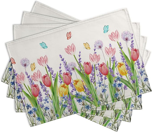 Stack of four square placemats with colorful tulip, lavender flowers, and butterflies
