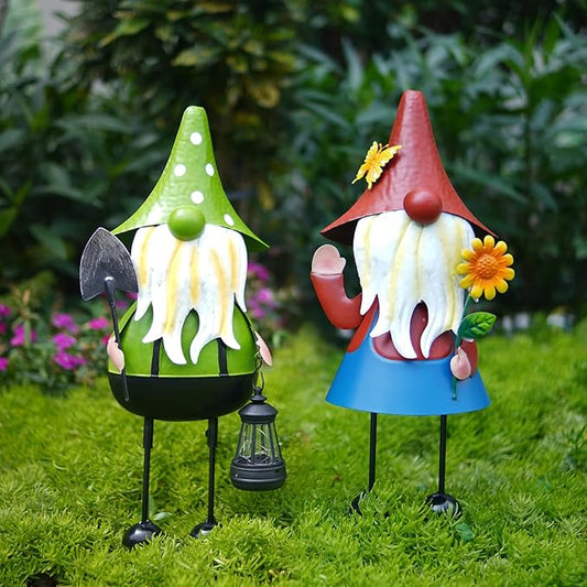 Pair of metal solar garden gnomes with red and green caps, flower accents, stakes