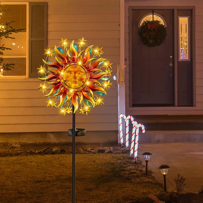 Solar metal sun wind spinner with warm LED lights on an outdoor porch stake
