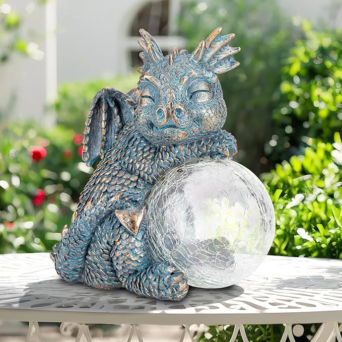Blue dragon figurine holding a crackled glass globe solar light on a tabletop