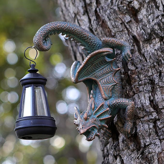 Dragon tree hugging wall decor with black solar lantern hanging from a dark bronze form