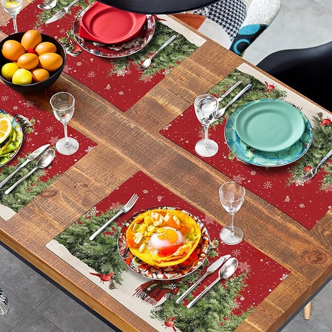 Red snowman placemat on table with dinnerware, pine-tree border and cardinals