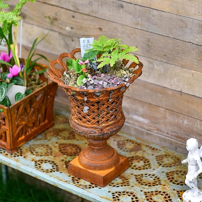 Cast-iron openwork trophy-style urn planter with lattice weave and pedestal base