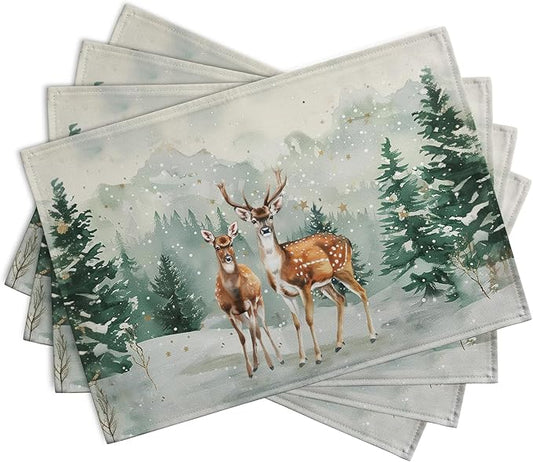 Set of four Christmas placemats, overlapping deer and pine forest in winter snow