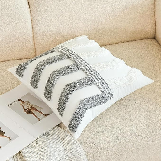 White pillow cover with thick gray arched lines on textured tufted front