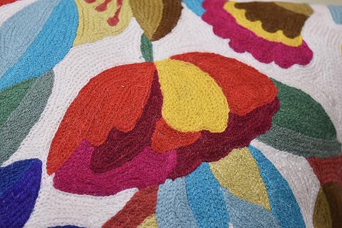 Close-up of layered flower embroidery in red, yellow, and blue on white fabric