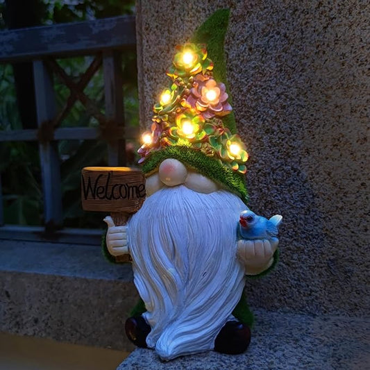 White resin gnome statue with “Welcome” sign, blue bird, and warm solar light garland