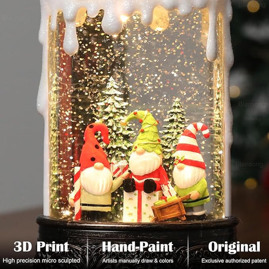 Close-up snow globe candle with Santa figures, Christmas trees, and golden glitter snowfall